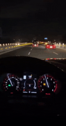 a car is driving down a highway at night and the speedometer reads 1:08