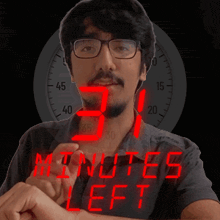 a man wearing glasses and a shirt that says " 31 minutes left "