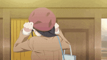 a girl wearing a beret and a brown jacket is holding a bag with a heart on it