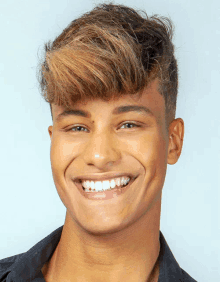 a close up of a young man 's face smiling