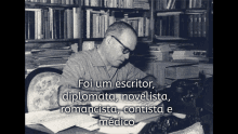 a black and white photo of a man sitting at a desk with the words " foi um escritor " written above him