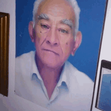 a portrait of an older man with white hair and gray eyebrows on a blue background