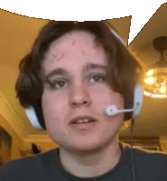 a young man wearing headphones and a microphone is making a funny face .