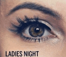 a close up of a woman 's eye with the words ladies night below it