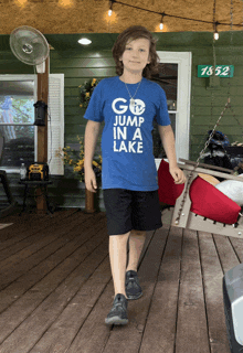 a boy wearing a shirt that says go jump in a lake