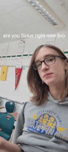 a girl wearing glasses and a state finals shirt