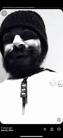 a black and white photo of a man with a beard and a usa zipper