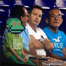 a man in a hollister t-shirt sits next to a boy in a green shirt