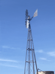 a windmill against a blue sky with a coca cola logo