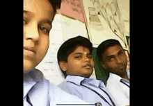 a group of children are taking a selfie in a classroom