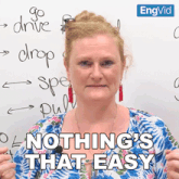a woman says nothing 's that easy in front of a white board with writing on it