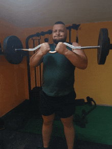 a man lifting a barbell in a gym