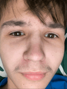 a close up of a person 's face with brown eyes