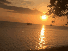 a sunset with a boat in the water