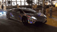 a silver car with a holographic sticker on the side