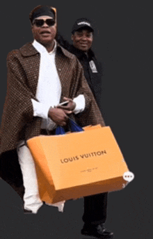 a man carrying a louis vuitton shopping bag