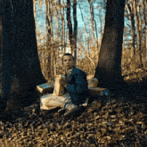 a person sitting in the woods with a bag of mcdonald 's