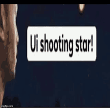 a man is standing in front of a sign that says `` ui shooting star ! ''