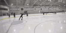 a person is skating on an indoor ice rink with a banner on the wall that says ' ice hockey '