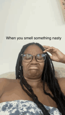 a woman with dreadlocks and glasses making a funny face with the caption when you smell something nasty