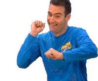 a man wearing a blue shirt that says the wiggles