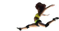 a woman in a yellow sports bra and black shorts jumps in the air