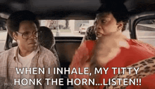 a man and a woman are sitting in the back seat of a car and the woman is talking to the man .