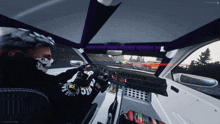 a man wearing a mask is driving a car in a game