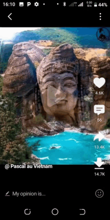 a phone screen shows a picture of a buddha statue in the middle of a body of water