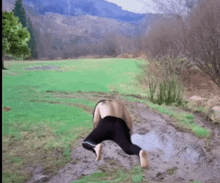 a person is crawling through a muddy field