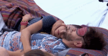 a man and a woman are hugging each other while wearing sleep masks .