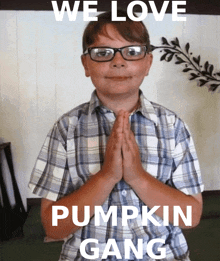 a young boy wearing glasses and a plaid shirt is praying with the words we love pumpkin gang below him