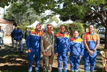 a group of people posing for a picture with one man wearing a shirt that says ' ambulance ' on it