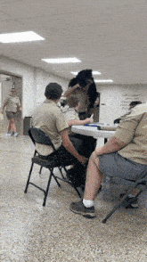 a group of boy scouts are sitting around a table with a white board that says " love is patient " on it