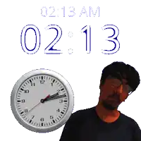 a man stands in front of a clock that says 2:13 am