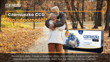 a man and woman hugging in a park with a box of czarnuszka ccd