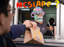 a man getting a bag of food from a mcdonald 's window