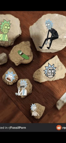 several rocks with rick and morty drawings on them are on a wooden table