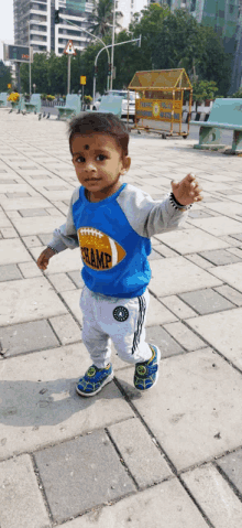 a young boy wearing a blue shirt with the word champ on it