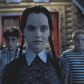 a woman with pigtails and a white collar