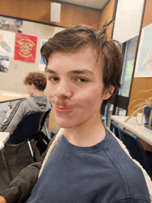 a boy with a bandage on his nose looks at the camera in front of a flag that says united states army