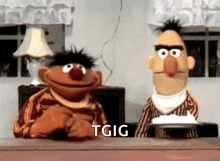 bert and ernie from sesame street sitting at a table with a plate of food