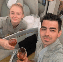 a man and a woman are toasting with champagne glasses