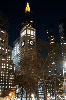 a tall building with a clock on top of it that says ' aaa ' on it