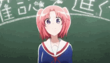 a girl with pink hair is standing in front of a chalkboard .