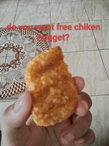 a person holding a piece of chicken nugget with the words do you want free chicken nugget written above it
