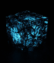 a blue cube with a black background is glowing