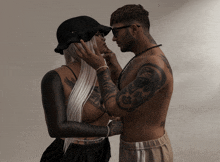 a man with a tattoo on his neck holds a woman 's face