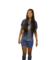 a woman in a blue shirt with the number 18 on it dancing