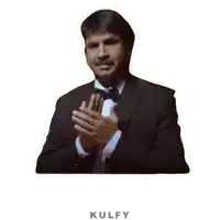 a man in a tuxedo and bow tie is clapping his hands